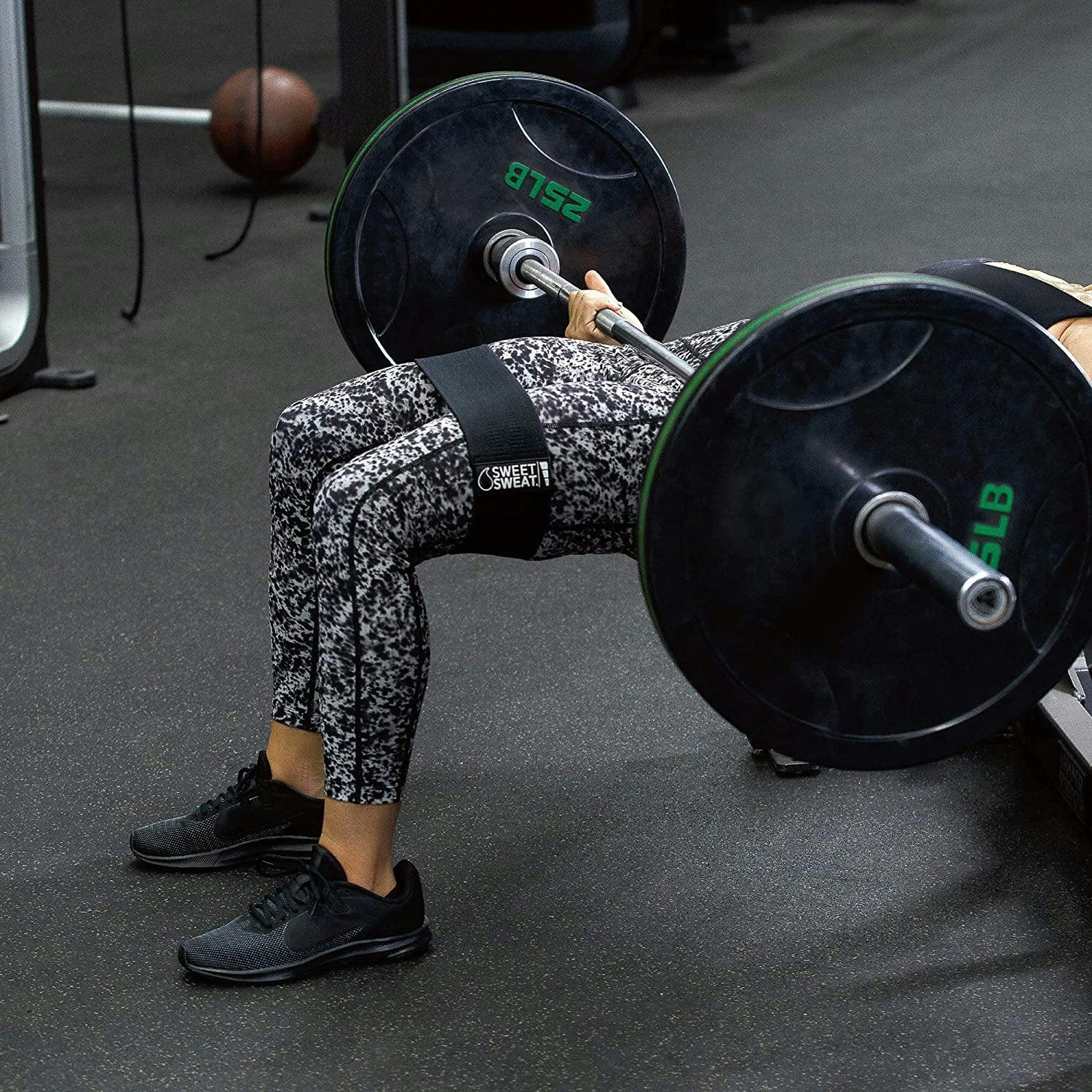 Woman using Sweet Sweat® Hip Bands and weighted bar during a workout.