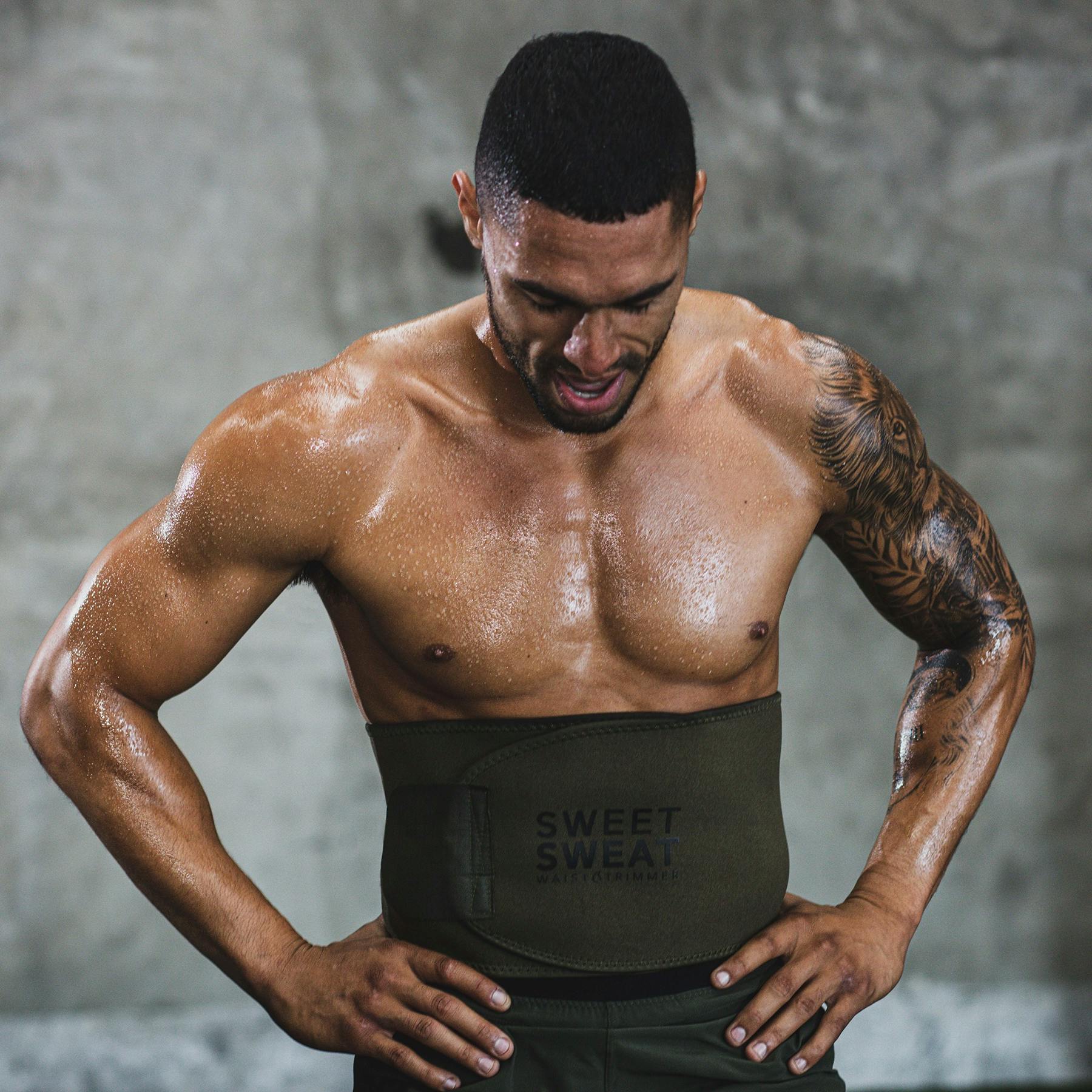 Man resting hands on his hips during a workout, while wearing a Sweet Sweat® Matte Series waist trimmer.