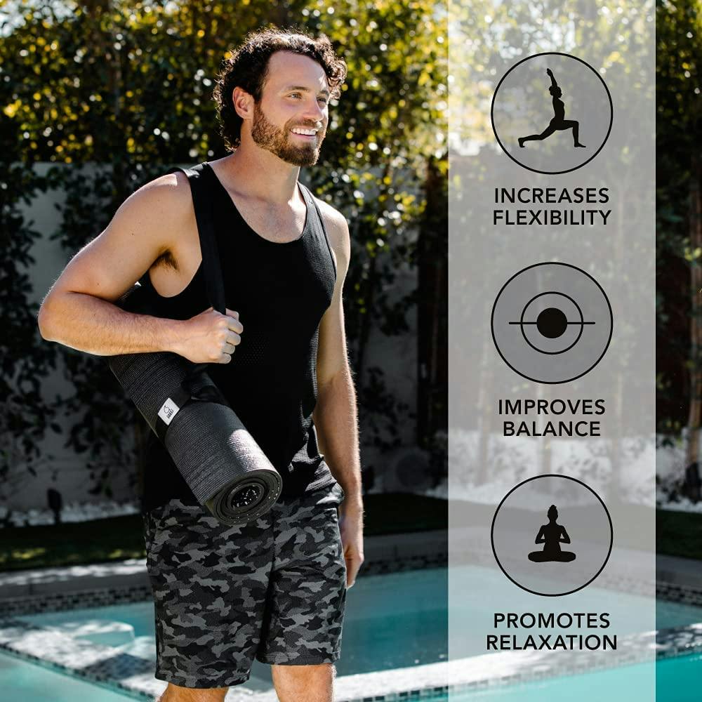 Man carrying Sweet Sweat® yoga mat with included strap.