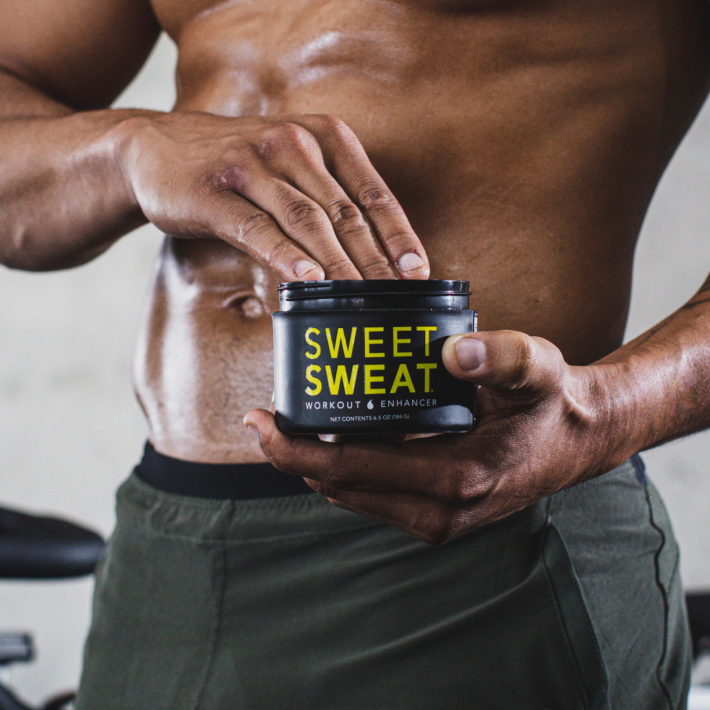 a man holding a jar of sweet sweat.